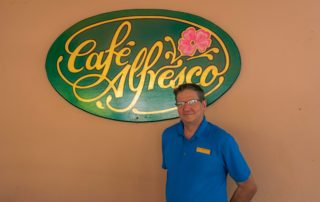 Kaveh stands in front of the Café Alfresco sign