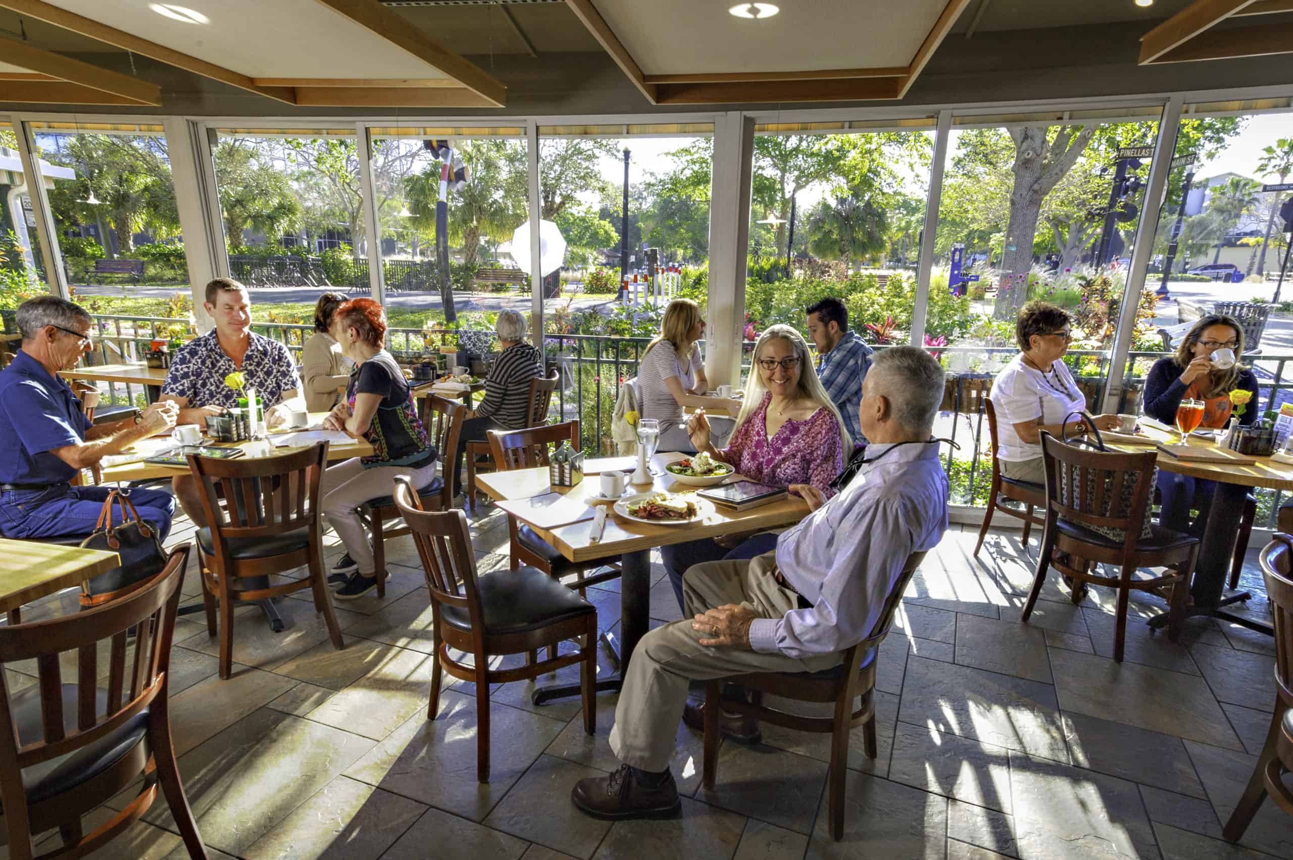 People dining in Café Alfresco's climate-controlled sun room.