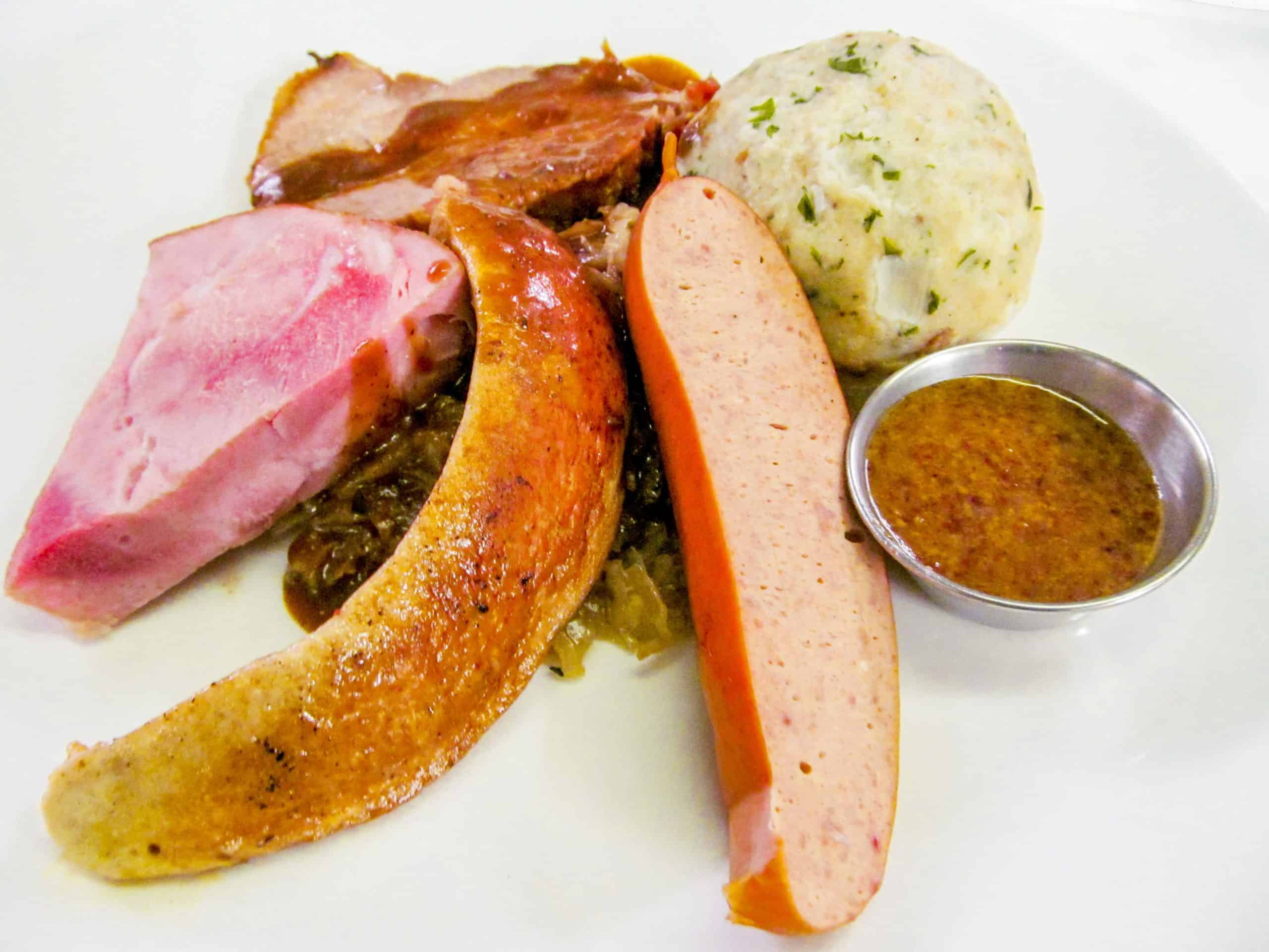 Platter of Oktoberfest foods like smoked ham, sausage, and liverwurst